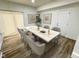 Stylish dining room with a marble-topped table, six chairs, modern art, and light wood flooring at 3811 N Lawndale Ave, Indianapolis, IN 46254
