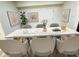 Stylish dining room with a marble-topped table, six chairs, modern art, and light wood flooring at 3811 N Lawndale Ave, Indianapolis, IN 46254
