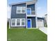 Charming two-story home with blue front doors, white trim, and an attached garage, and manicured lawn at 3811 N Lawndale Ave, Indianapolis, IN 46254