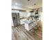 Bright modern kitchen with stainless steel appliances, white cabinetry, granite counters, island with seating at 3811 N Lawndale Ave, Indianapolis, IN 46254