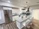 Bright modern kitchen with stainless steel appliances, white cabinetry, granite counters, island with seating at 3811 N Lawndale Ave, Indianapolis, IN 46254