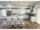 Bright modern kitchen with stainless steel appliances, white cabinetry, granite counters, island with seating at 3811 N Lawndale Ave, Indianapolis, IN 46254