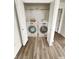 Convenient laundry closet featuring modern washer and dryer, and wood floors at 3811 N Lawndale Ave, Indianapolis, IN 46254