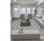 Bright living room featuring a gray sofa, chairs, ottoman, a decorative rug and large windows at 3811 N Lawndale Ave, Indianapolis, IN 46254