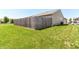 View of a grassy backyard with a wooden fence and surrounding houses at 4033 Tahoe Dr, Indianapolis, IN 46235