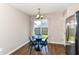 Bright dining area with hardwood floors, modern lighting, and a view of the backyard at 4033 Tahoe Dr, Indianapolis, IN 46235