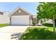 Inviting single-Gathering home with a two-car garage and a neatly landscaped front yard at 4033 Tahoe Dr, Indianapolis, IN 46235