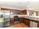 Modern kitchen with stainless steel appliances, dark cabinets, and a bright, airy feel at 4033 Tahoe Dr, Indianapolis, IN 46235