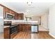 Updated kitchen with stainless steel appliances, recessed lighting and open view to another room at 4033 Tahoe Dr, Indianapolis, IN 46235