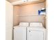 Laundry room features a full sized white washer and dryer with some shelving above at 4033 Tahoe Dr, Indianapolis, IN 46235