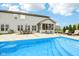 Backyard view features a swimming pool, patio dining and lounging area, and well manicured lawn at 4204 Omaha Dr, Bargersville, IN 46106