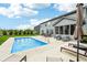 Spacious backyard featuring an in-ground pool, patio dining set, sun loungers, and professional landscaping at 4204 Omaha Dr, Bargersville, IN 46106