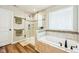 Bright bathroom featuring a soaking tub and a separate glass-enclosed shower at 4204 Omaha Dr, Bargersville, IN 46106