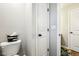 Bathroom includes a toilet and a view into a second bathroom with two white paneled doors at 4204 Omaha Dr, Bargersville, IN 46106