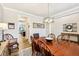Charming dining area with wood floors, a large table setting, modern lighting, and easy access to kitchen and living spaces at 4204 Omaha Dr, Bargersville, IN 46106