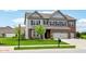Well-maintained home with gray siding, brick accents, a spacious front lawn, and a convenient attached three-car garage at 4204 Omaha Dr, Bargersville, IN 46106