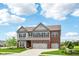 Charming two-story home features a brick and gray exterior, manicured lawn, and a convenient three-car garage at 4204 Omaha Dr, Bargersville, IN 46106