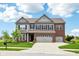 Beautiful two-story home with gray siding, brick accents, a well-manicured lawn, and an attached three-car garage at 4204 Omaha Dr, Bargersville, IN 46106