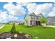 Attractive two-story home boasts lush lawn, mature trees, manicured landscaping, and an attached three-car garage at 4204 Omaha Dr, Bargersville, IN 46106