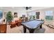 Game room with pool table, leather furniture, ceiling fan, and natural light at 4204 Omaha Dr, Bargersville, IN 46106
