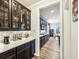 Elegant kitchen featuring dark cabinetry, quartz countertops, and wine storage at 4204 Omaha Dr, Bargersville, IN 46106
