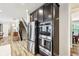 Gourmet kitchen with stainless steel appliances and dark wood cabinetry at 4204 Omaha Dr, Bargersville, IN 46106