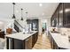 Modern kitchen with dark cabinets, island with seating, and stainless steel appliances at 4204 Omaha Dr, Bargersville, IN 46106