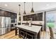 Kitchen island with seating, stainless steel appliances and dark cabinets at 4204 Omaha Dr, Bargersville, IN 46106