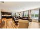 Open concept living room with wood floors, leather furniture, and bright natural light at 4204 Omaha Dr, Bargersville, IN 46106
