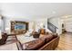 Inviting living room with wood floors, plush leather seating, custom entertainment center, and ample natural light at 4204 Omaha Dr, Bargersville, IN 46106