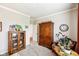 Comfortable living room with a bookcase and classic wooden armoire at 4204 Omaha Dr, Bargersville, IN 46106