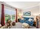 Cozy living room with a plush blue sofa and a large window overlooking the yard at 4204 Omaha Dr, Bargersville, IN 46106