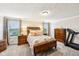 Spacious main bedroom with a large window, wooden furniture, and neutral decor at 4204 Omaha Dr, Bargersville, IN 46106