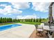 Inviting backyard oasis featuring a pool, lush green lawn, and comfortable seating area for outdoor relaxation at 4204 Omaha Dr, Bargersville, IN 46106
