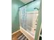 Bathroom featuring a bathtub with a white shower surround and a blue patterned shower curtain at 424 S Parker Ave, Indianapolis, IN 46201