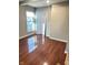 Bedroom featuring gleaming hardwood floors, a window, and neutral walls at 424 S Parker Ave, Indianapolis, IN 46201
