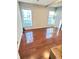 Bedroom featuring gleaming hardwood floors, two windows, and neutral walls at 424 S Parker Ave, Indianapolis, IN 46201
