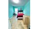 Cozy bedroom featuring wood floors, turquoise walls, and simple decor at 424 S Parker Ave, Indianapolis, IN 46201