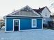 Exterior of a charming blue home featuring fresh gravel landscaping at 424 S Parker Ave, Indianapolis, IN 46201