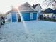 Exterior of a charming blue home with fresh gravel landscaping and sunlight at 424 S Parker Ave, Indianapolis, IN 46201