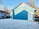 A blue garage with a white door and gravel base, providing secure parking and storage at 424 S Parker Ave, Indianapolis, IN 46201
