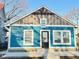 Charming bungalow with light blue wood siding, a front door, and white trim at 424 S Parker Ave, Indianapolis, IN 46201