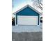 The garage has a modern white door and gravel surroundings, perfect for secure parking at 424 S Parker Ave, Indianapolis, IN 46201