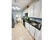 Functional kitchen featuring white cabinets, a stainless steel sink, and modern appliances at 424 S Parker Ave, Indianapolis, IN 46201