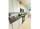 Bright kitchen featuring white cabinets, granite countertops, and stainless steel appliances at 424 S Parker Ave, Indianapolis, IN 46201