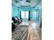 Bright living room with wood floors, a black leather sofa, and plenty of natural light at 424 S Parker Ave, Indianapolis, IN 46201