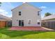 Home's backyard features a patio, a small lawn, and a view of the rear exterior of the home at 4316 Village Trace Dr, Indianapolis, IN 46254