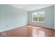 Bedroom with wood floors and a window at 4316 Village Trace Dr, Indianapolis, IN 46254