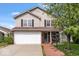 Charming two-story home featuring a two-car garage and a welcoming brick-lined walkway leading to the front door at 4316 Village Trace Dr, Indianapolis, IN 46254