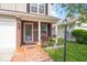 Inviting entrance with brick accents, a charming flower garden, and a decorative address post, creating a warm welcome at 4316 Village Trace Dr, Indianapolis, IN 46254